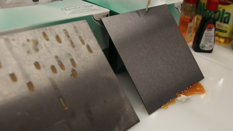 Left, food particles can accumulate on an untreated stainless steel surface, increasing the risk of contamination in food production facilities. Right, the oil-treated surface, repels material. Credit: Liz Do