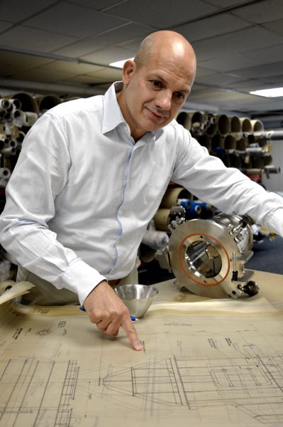 Johan Lucas, inspects blueprints with KEK cone mill component