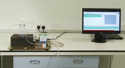 Figure 4: Bottle connected to the particle counter with trigger head under test in place